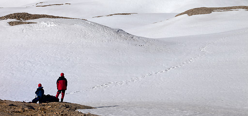 Image showing Two hikers on halt in snowy mountain