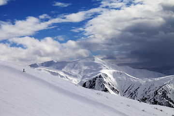 Image showing Ski slope in evening and storm clouds