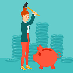 Image showing Woman breaking piggy bank.