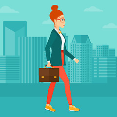 Image showing Business woman walking with briefcase. 