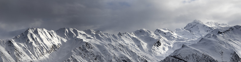 Image showing Panoramic view on high sunlight mountains and storm sky before b