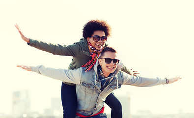 Image showing happy teenage couple in shades having fun outdoors