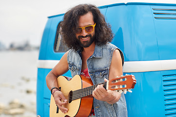 Image showing hippie man playing guitar over minivan car outdoor