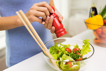 Image showing close up of woman cooking vegetable salad at home