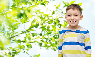 Image showing smiling little boy over green natural background