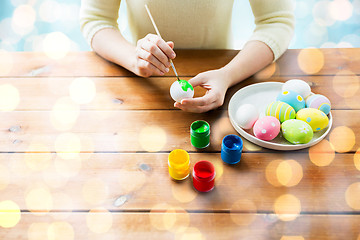 Image showing close up of woman hands coloring easter eggs