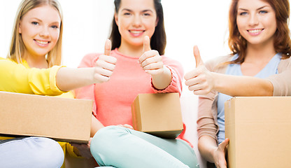 Image showing close up of teenage girls with cardboard box