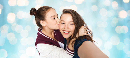 Image showing happy teenage girls taking selfie and kissing