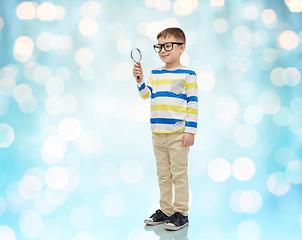 Image showing little boy in eyeglasses with magnifying glass