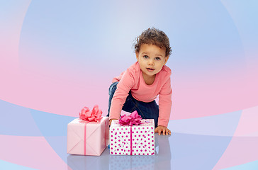 Image showing baby girl with birthday presents and confetti