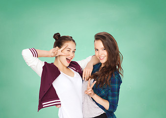 Image showing happy teenage student girls showing peace sign