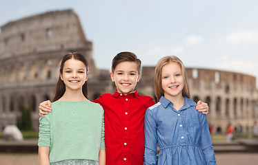 Image showing happy boy and girls hugging over coliseum in rome