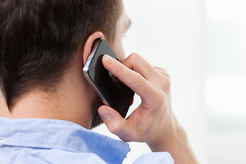 Image showing close up of man calling on smartphone at home