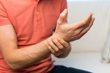 Image showing close up of man with  pain in hand at home