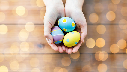 Image showing close up of woman hands with colored easter eggs