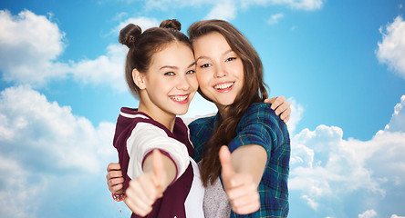 Image showing happy smiling teenage girls showing thumbs up