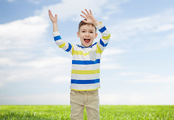 Image showing happy little boy waving hands