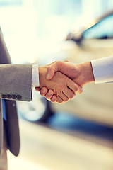 Image showing close up of male handshake in auto show or salon