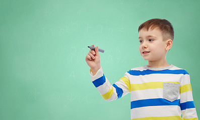 Image showing little boy drawing or writing with marker