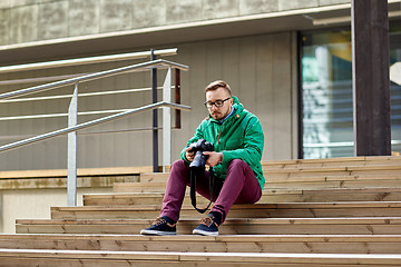 Image showing young hipster man with digital camera in city