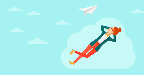 Image showing Business woman relaxing on cloud.