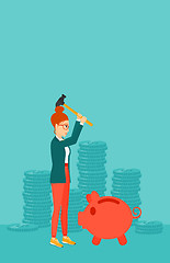 Image showing Woman breaking piggy bank.