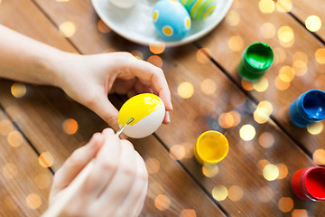 Image showing close up of woman hands coloring easter eggs