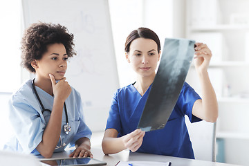 Image showing female doctors with x-ray image at hospital