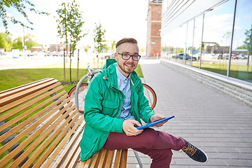 Image showing happy young hipster man with tablet pc and bike