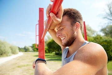 Image showing man with heart-rate watch exercising outdoors