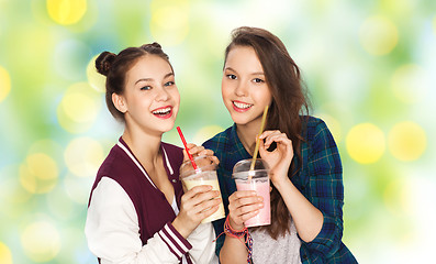 Image showing happy pretty teenage girls drinking milk shakes