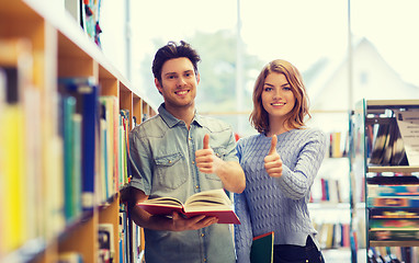 Image showing happy student couple with books in library