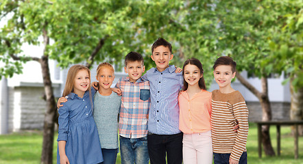 Image showing happy smiling children hugging over backyard