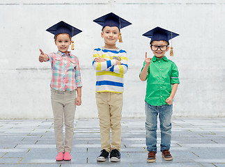 Image showing happy children in bachelor hats and eyeglasses