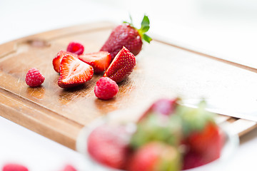 Image showing close up of ripe red strawberries on cutting board