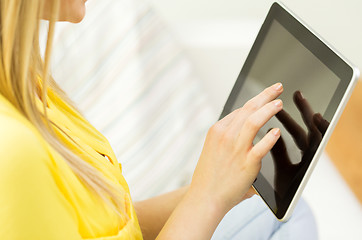 Image showing close up of young woman with tablet pc at home