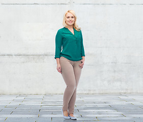 Image showing smiling young woman in shirt and trousers