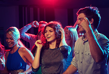 Image showing group of happy friends dancing in night club