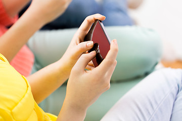 Image showing close up of hands texting on smartphone at home