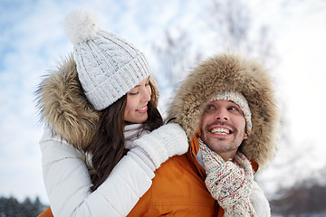 Image showing happy couple having fun over winter background