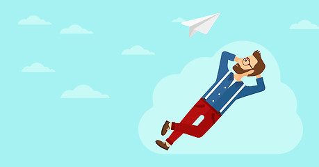 Image showing Businessman relaxing on cloud.