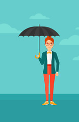 Image showing Business woman standing with umbrella.