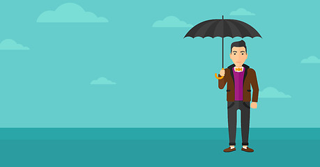 Image showing Businessman standing with umbrella.