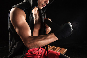 Image showing The hands of muscular man with bandage