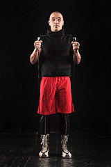 Image showing The legs of muscular man with skipping rope