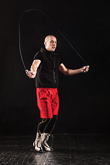 Image showing The legs of muscular man with skipping rope