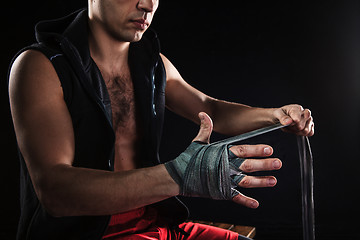 Image showing The hands of muscular man with bandage