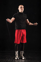 Image showing The legs of muscular man with skipping rope