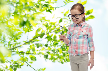 Image showing little girl in eyeglasses with magnifying glass