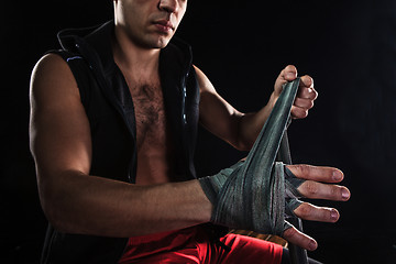 Image showing The hands of muscular man with bandage
